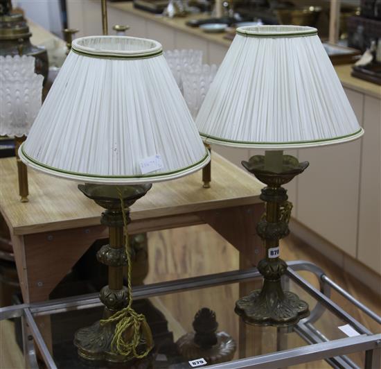 A pair of brass candlesticks converted to lamps